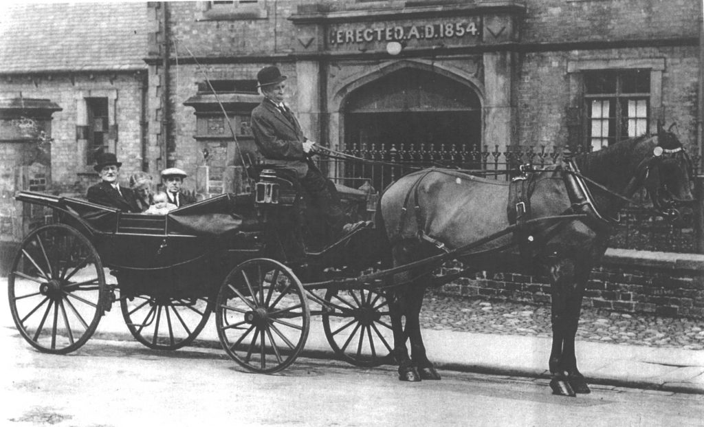 An archive photo of the Workhouse Museum featuring a horse and cart