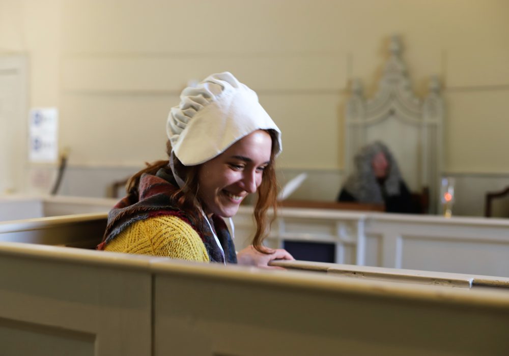 A woman in costume in the courthouse dock
