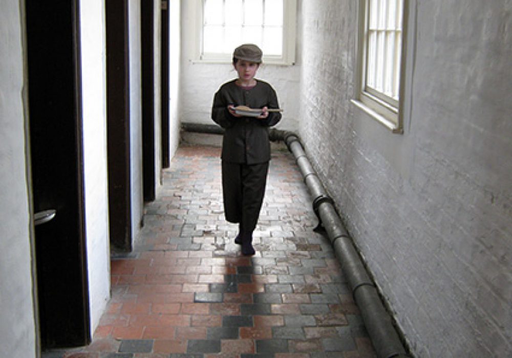 Boy in the workhouse corridor