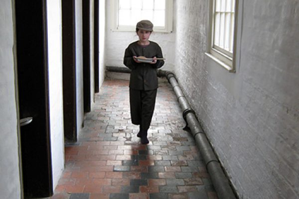 Boy in the workhouse corridor