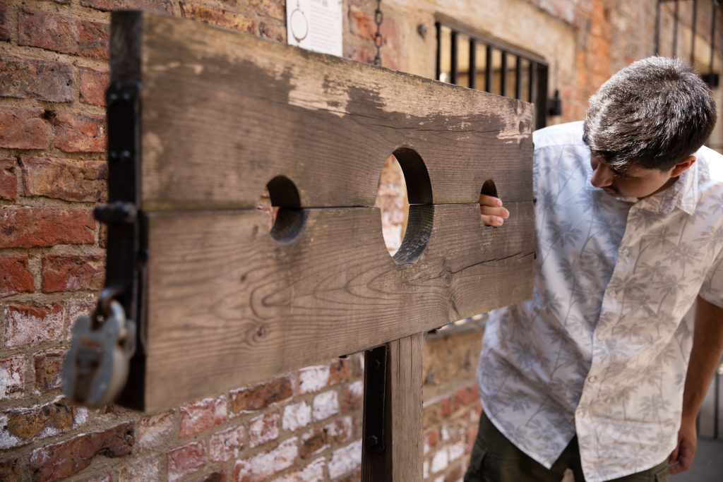 A young man examining wooden stocks