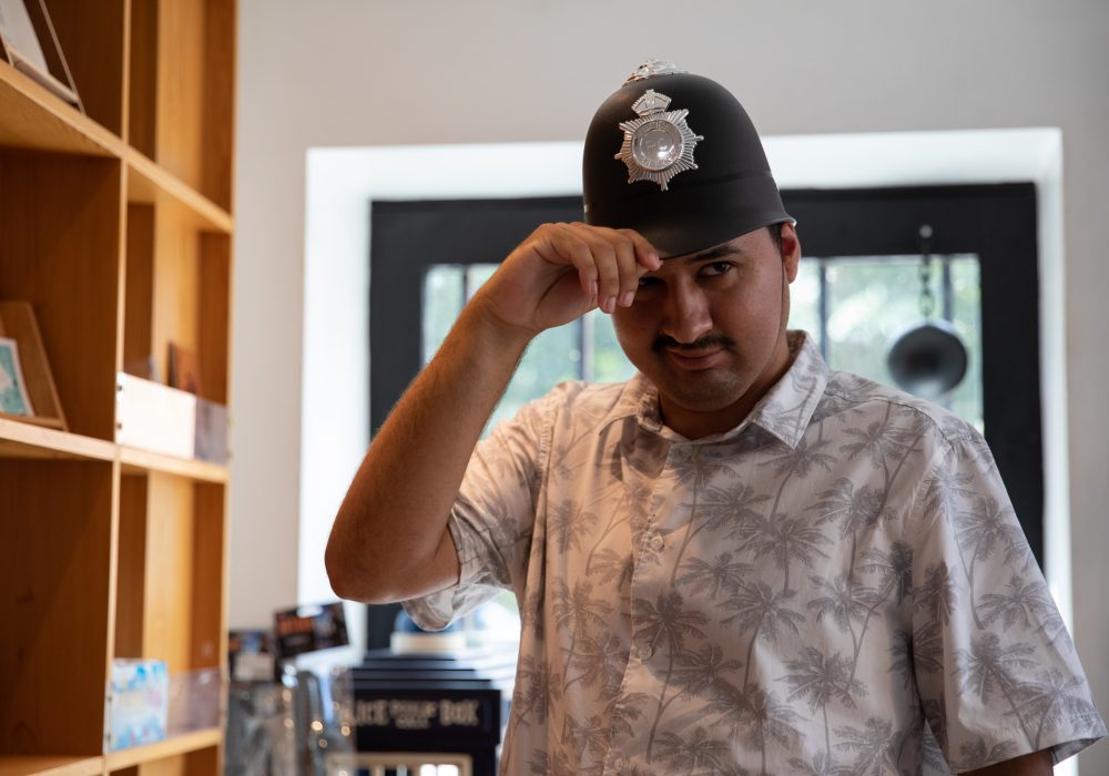A man wearing a policeman's helmet