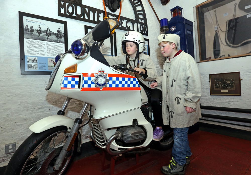 Two children sitting on a police motorbike