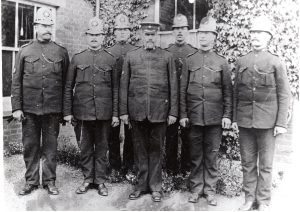 Seven Norfolk constables photographed in an unknown location. From their helmets, the photograph can be dated between 1909 and 1922.