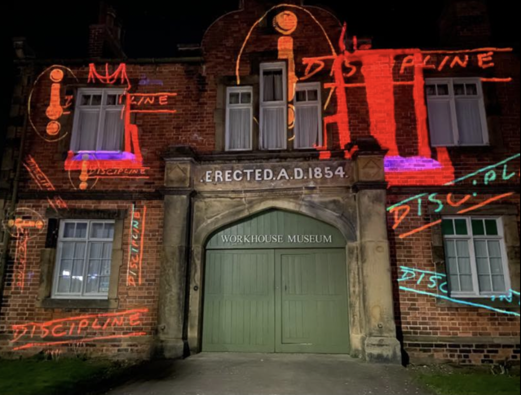 Projection on the front of the Workhouse Museum