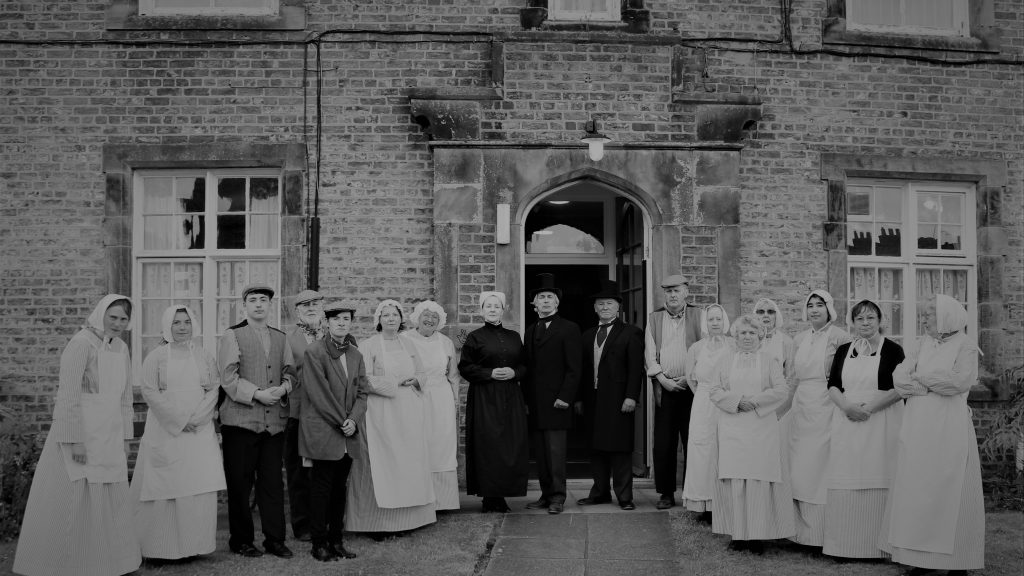 Theatre group outside the Ripon Workhouse wearing victorian clothes