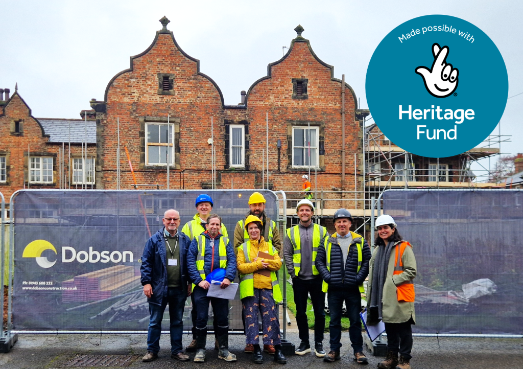 A team of people standing in front of the Workhouse Museum